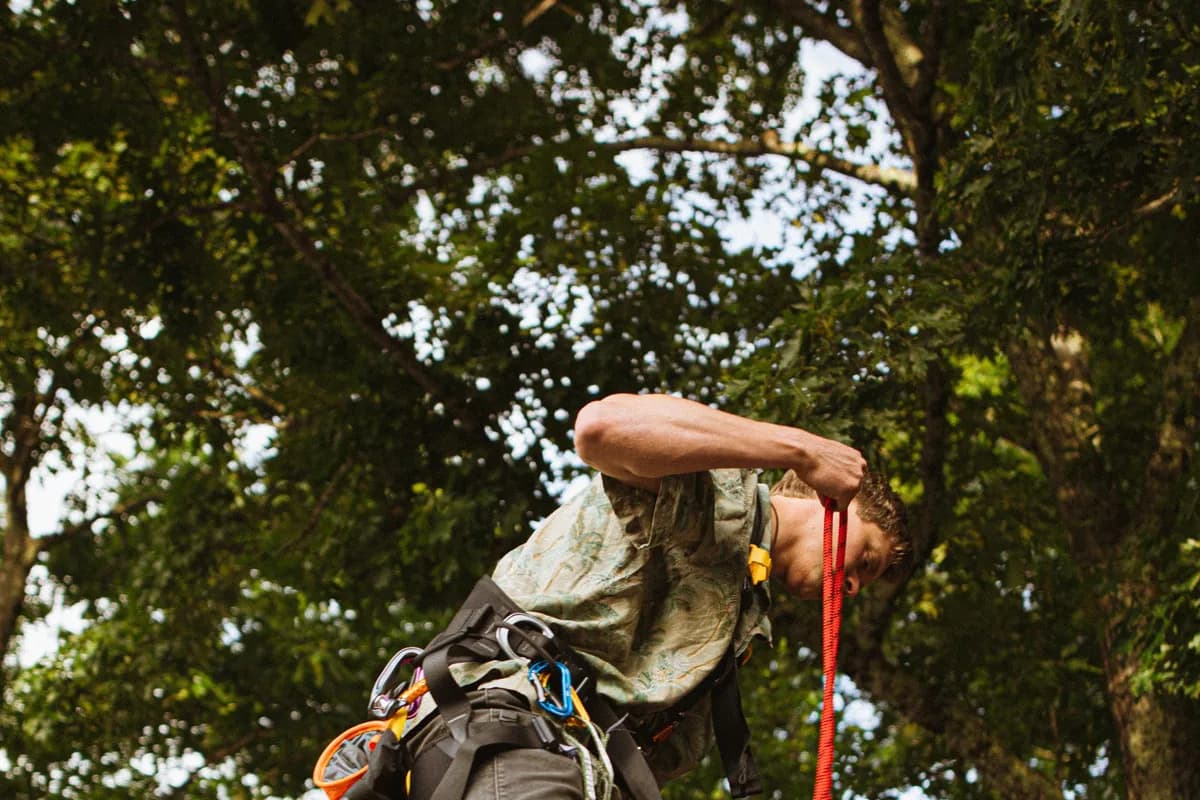 Roofing contractor in safety gear working on a residential roof