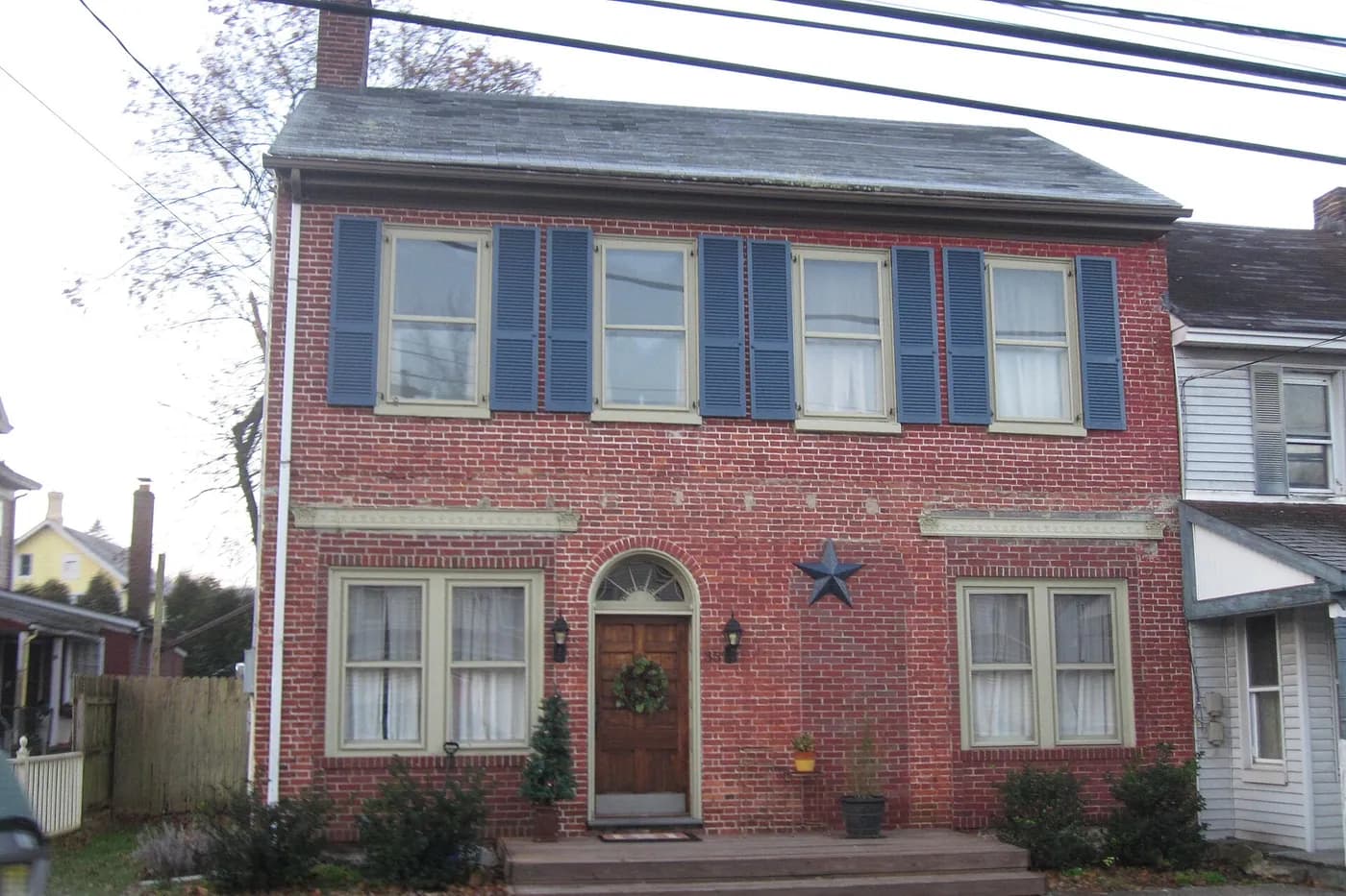 Older two-story house with a pitched roof in Bloomsbury, New Jersey